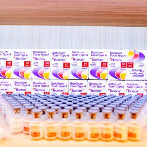 A table full of boxes and cups with pills.