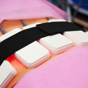 A pink sheet with two white computer keyboards.